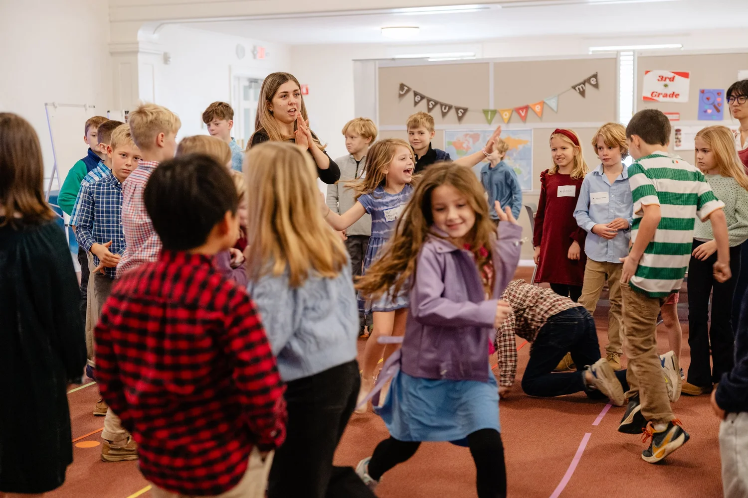 A Sunday School teacher leads children in songs and games in the children&rsquo;s space
