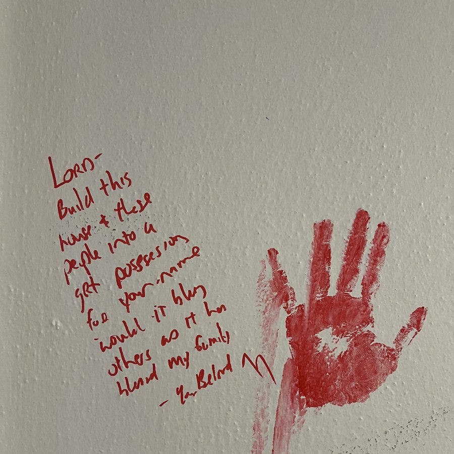 A handwritten prayer beside a red painted handprint: "Lord, build this house and these people into a great possession for your name"