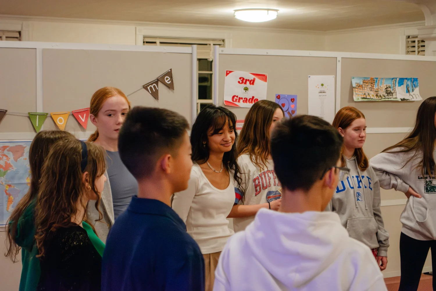 Middle school students talking together at Rooted
